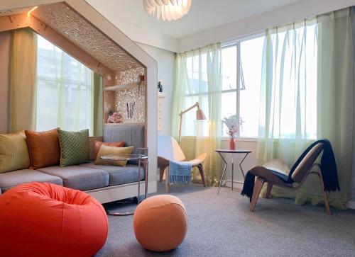 a living room with a couch and a table and chairs at Central Nest- view & style in Wellington