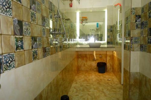 a bathroom with a sink and a mirror at Hotel HCB (Hemo Chandra Bhawan) in Brahmapur