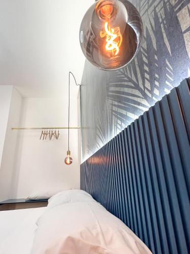 a bedroom with a bed with a blue head board at The Apartment Agrigento in Agrigento