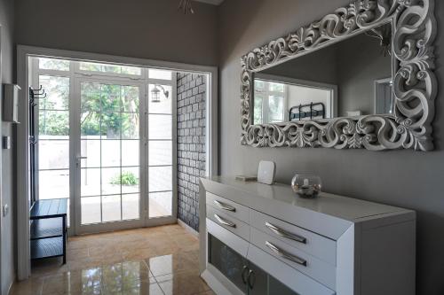 a bathroom with a white dresser and a mirror at Casa Las Peras, La Laguna in Las Lagunas