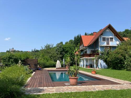 a house with a swimming pool in the yard at Apartment mit Pool und Aussicht in Kitzeck im Sausal