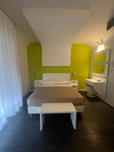 a bedroom with a bed and two sinks in it at Hotel Magic in Riccione