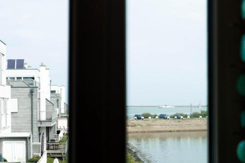 a view of a river from a window at Katamaran in Olpenitz
