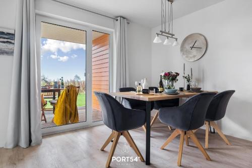 a dining room with a table and chairs at Place to be in Olpenitz