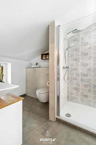 a bathroom with a shower and a toilet at Villa Nova in Büsum
