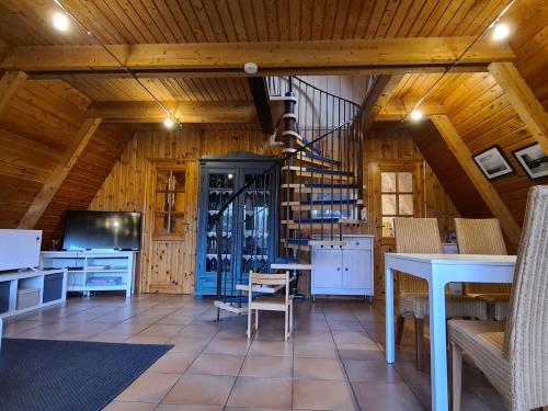a dining room with a table and a wine cellar at Nordwind in Damp
