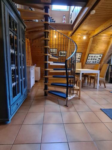 a spiral staircase in a room with a table at Nordwind in Damp