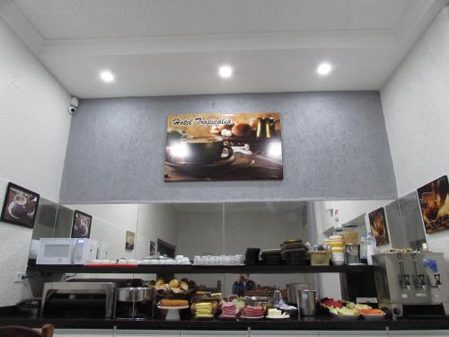 a sign on the wall of a kitchen with food at Hotel Tropicália próximo a 25 de março , Brás e Bom Retiro "Com estacionamento conveniado ao lado do hotel" in Sao Paulo