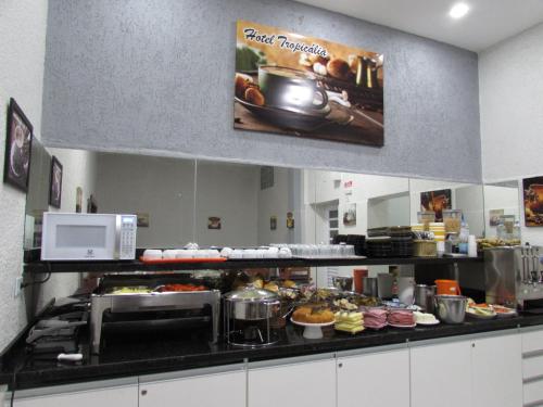 a kitchen with a bunch of food on a counter at Hotel Tropicália próximo a 25 de março , Brás e Bom Retiro "Com estacionamento conveniado ao lado do hotel" in Sao Paulo
