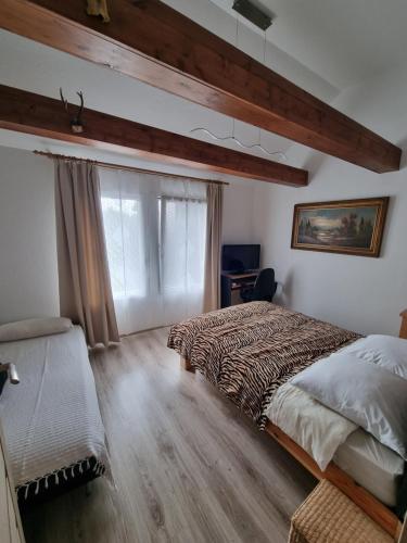 a bedroom with a large bed and a window at Privati valda in Šventoji