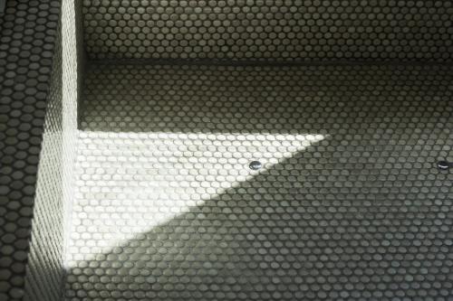 a bathroom floor with a white beam of light at 31page in Seoul