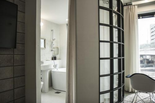 a bathroom with a tub and a sink and a chair at 31page in Seoul