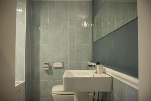 a bathroom with a sink and a toilet and a mirror at 31page in Seoul