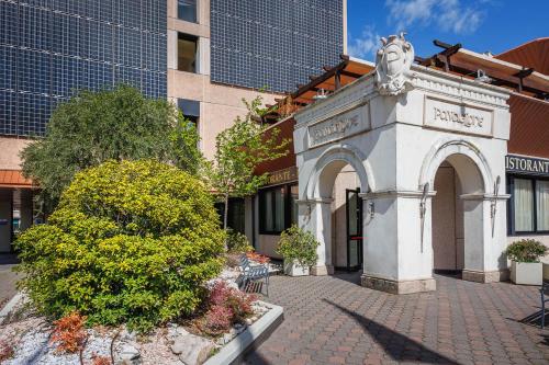 a building with an arch in front of a building at JR Hotels Bologna Amadeus in Bologna
