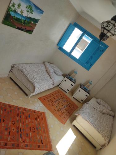 an overhead view of a bedroom with two beds and a window at Taghazout Ocean View in Taghazout