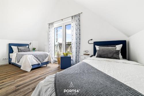 Giường trong phòng chung tại Lütte Diekhuus