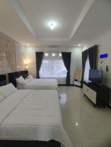 Ένα ή περισσότερα κρεβάτια σε δωμάτιο στο Griya Adevita Sidoarum