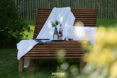 a wooden bench with a table with flowers on it at Reethüs Schleiblick in Selk