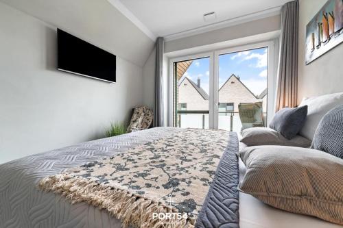 a bedroom with a bed and a tv and a couch at Hannes in Büsum