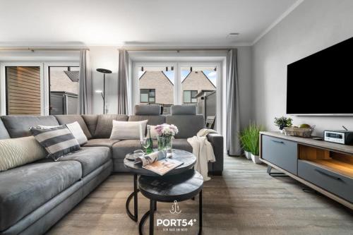 a living room with a couch and a flat screen tv at Hannes in Büsum