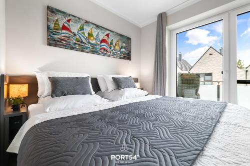 a bedroom with a large bed and a large window at Hannes in Büsum