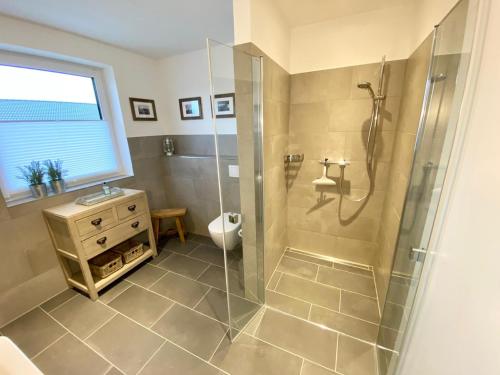 a bathroom with a shower and a toilet at Sandpiper in Gelting