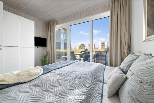 En eller flere senge i et værelse på Ferienhaus Lagunenblick 38 Marina Wendtorf