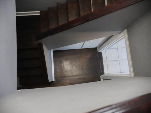 a room with a staircase and a window and a wall at Kingsworth inn Port Elizabeth in Port Elizabeth