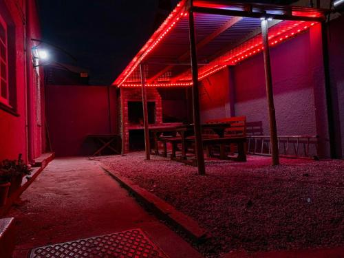 a red lighted patio with a bench in a building at Kingsworth inn Port Elizabeth in Port Elizabeth