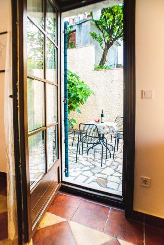 an open door to a patio with a table and chairs at Villa Chantal in Kotor