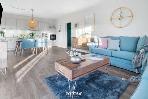 a living room with a blue couch and a table at Lake House in Osterhever