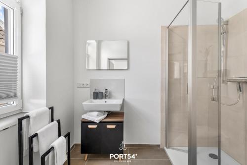 a bathroom with a sink and a shower at Strandmuschel Gelting in Gelting