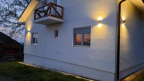 a white house with a balcony on the side of it at Vila Sava in Sopot