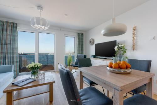 a living room with a table with oranges on it at Marinablick in Olpenitz