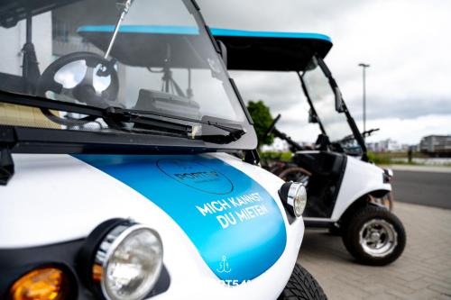 a golf cart with a sticker on the front at Harbour House in Olpenitz