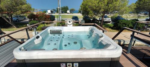 a bath tub sitting on top of a deck at Floating House Sea Queen in Portorož