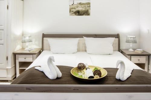 a bedroom with a bed with a plate of food on it at Biberburg in Flensburg
