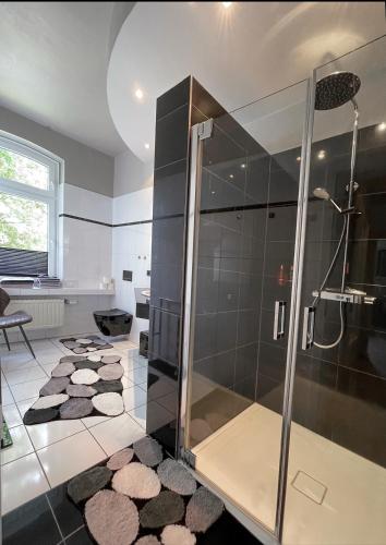 a bathroom with a shower with a glass door at Time2Lounge in Osnabrück