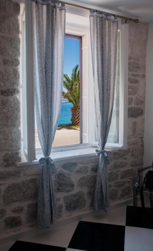 a window with a view of the ocean at Apartments Jasmina in Korčula