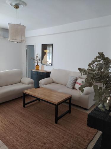 a living room with a couch and a coffee table at La Zagala in Badajoz