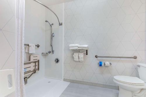 biała łazienka z toaletą i prysznicem w obiekcie Comfort Suites Golden West on Evergreen Parkway w mieście Evergreen