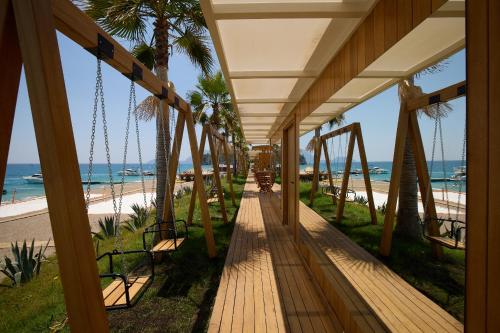 a porch with a view of the beach at Mövenpick Resort Antalya Tekirova - Ultra All Inclusive in Tekirova