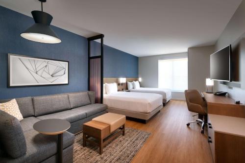 a hotel room with a bed and a couch at Hyatt Place Fayetteville/Springdale in Fayetteville