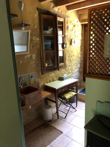 cocina con fregadero y mesa en una habitación en Gascony Guest House, en Castéra-Verduzan