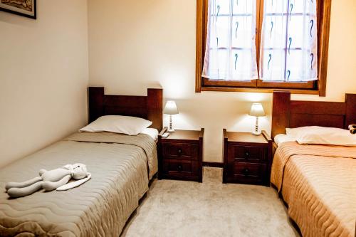 a bedroom with two beds and a window at Villa Chantal in Kotor