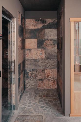 a stone wall in a room with a hallway at Experience in Valle Varaita - Rustico con SPA Privata - Piscina - Sauna - Hammam - Free Wi-Fi in Brossasco