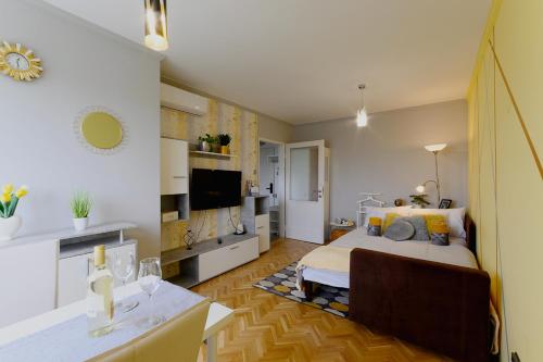 a bedroom with a bed and a living room at Parkside double room in Budapest