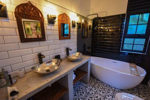 a bathroom with two sinks and a large tub at Private Villa at the Source of the Nile in Jinja