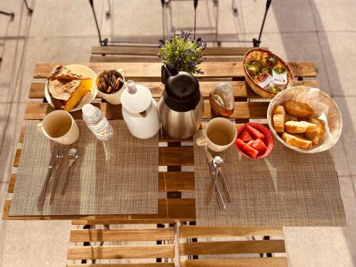 a wooden table with breakfast foods on it at Hostal Lóbrega in Torrecilla en Cameros