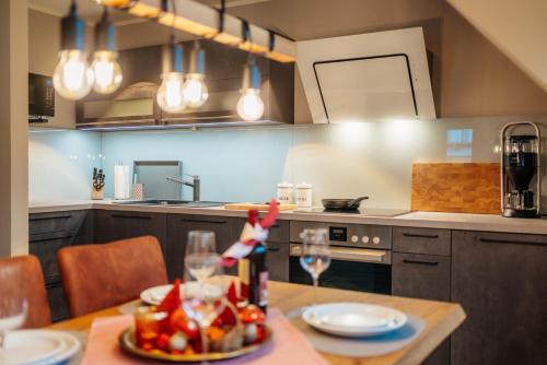 a kitchen with a table with wine glasses on it at Baude III in Braunlage